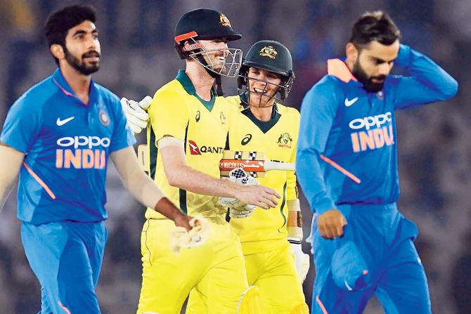 India captain Virat Kohli (right) walks away disappointed after yesterday