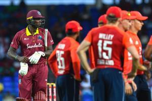 Jason Holder (L) of West Indies walks off the field dismissed by Chris Jordan of England during the 2nd T20I between West Indies England at Warner Park, Basseterre, Saint Kitts and Nevis. Pic/AFP
