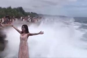 Watch: Huge wave sweeps away woman while posing for photo by the sea