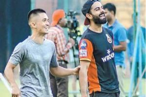 Virat Kohli has fun with Sunil Chhetri during RCB training camp