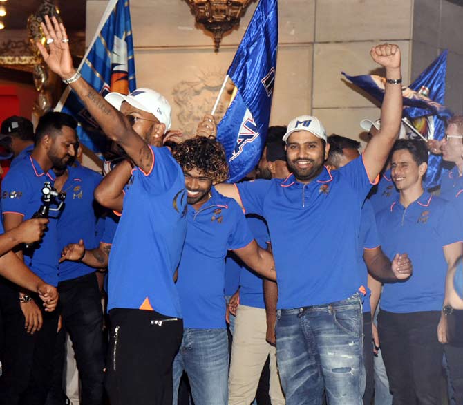 A victorious Mumbai Indians team wave to the fans at Antilia for the grand IPL party