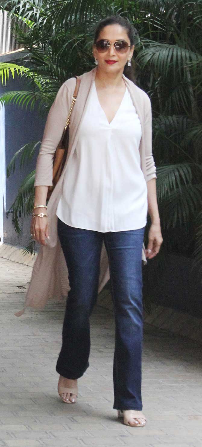 Madhuri Dixit kept her look simple opting for white top paired with denim and beige color shrug. Her aviator sunglasses and billion dollar smile enhanced her look. On the other hand, Sriram Nene looked dapper in his casual blue polo t-shirt and dark blue pants. (All photos/Yogen Shah)