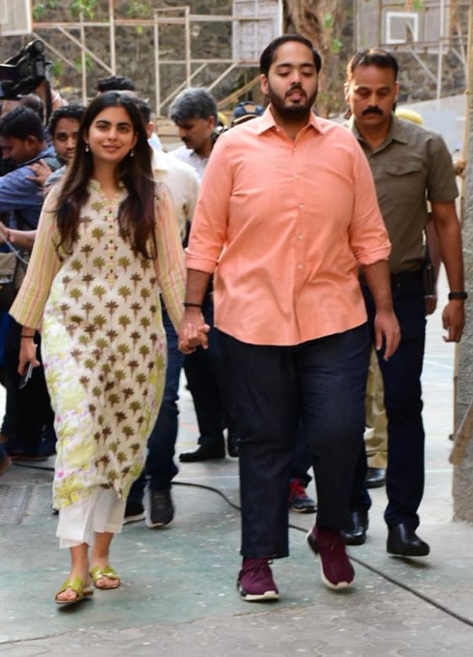 In pic: Holding her younger brother Anant Ambani's hand, Isha Ambani walks out of the polling booth towards her car.