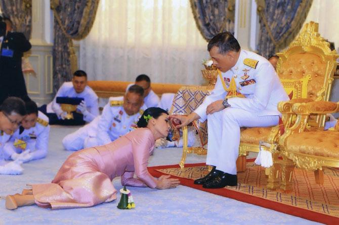 Thai television, which broadcast the royal order showed a video of Suthida prostrating herself before the king, to whom she, according to the announcer, presented a tray of flowers and joss sticks, and in return was bestowed traditional gifts associated with royal power. It also showed the king in a white uniform and his bride in a pink silk traditional dress formally registering their marriage on Wednesday in his palace residence in the capital, Bangkok. It showed what the television announcer said was the couple signing a marriage certificate book, which was also signed by the king's sister, Princess Sirindhorn, and Privy Council head Prem Tinsulanonda as witnesses