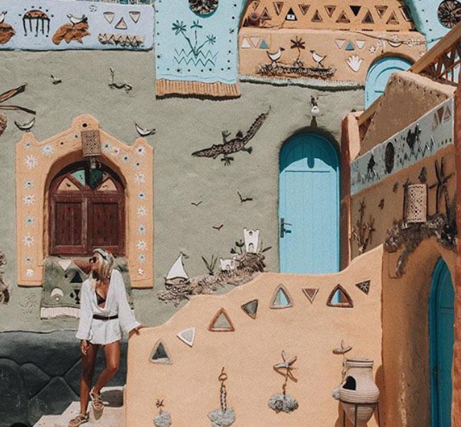 Lauren Bullen poses in Egypt against Colourful Nubian village. She captions this picture as 'Colourful Nubian village, feelin' like an Egyptian Alice in Wonderland'