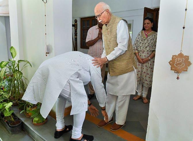 Prime Minister Narendra Modi seeks blessings from BJP's senior leader LK Advani after their victory in the Lok Sabha elections, in New Delhi, Friday, May 24, 2019