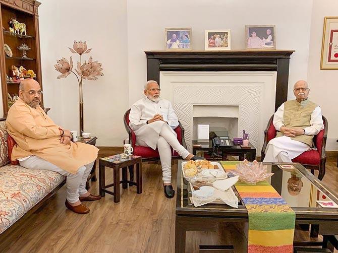 Prime Minister Narendra Modi and BJP President Amit Shah meet party's senior leader LK Advani after their victory in the Lok Sabha elections, in New Delhi, Friday, May 24, 2019