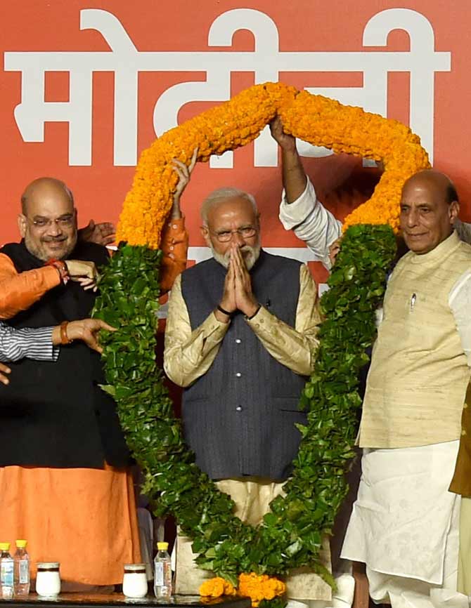 Prime Minister Narendra Modi being garlanded by BJP's senior leaders as he arrives at the party headquarters to celebrate the party's victory in the 2019 Lok Sabha elections, in New Delhi, Thursday, May 23, 2019