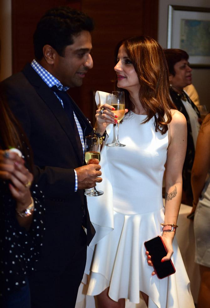 In pic: Shobhaa De's son Aditya Khilachand and interior fashion designer Sussanne Khan have a candid conversation at the party in Colaba. 