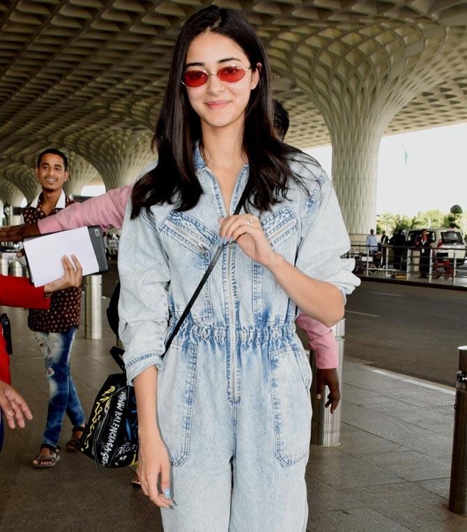 Ananya Panday wore a denim jumpsuit as she was spotted with her Student Of The Year 2 co-stars at the Mumbai airport. Chunky Panday's daughter is currently on a promotional spree of her debut film. The actress will also be seen opposite Kartik Aaryan in the remake of the film, Pati Patni Aur Woh.