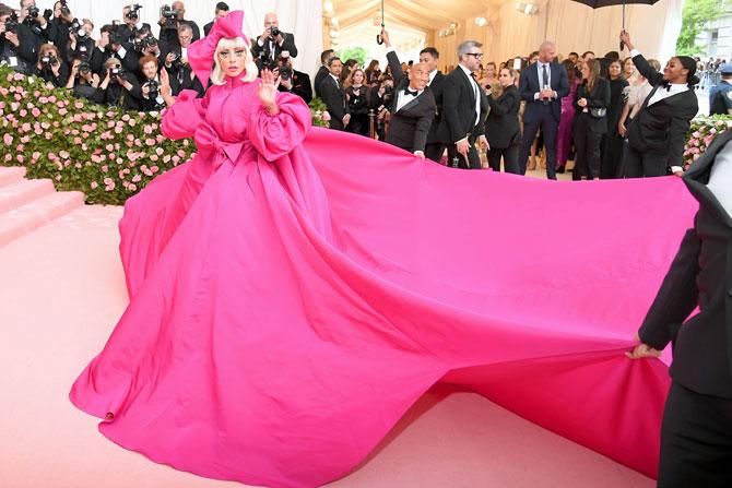 Lady Gaga caught everyone's attention with her dramatic costume changes on the red carpet of the big event. She wore a stunning billowing fuchsia gown by Brandon Maxwell. To complete her look, Gaga wore a matching pink bow and big lashes that transformed into gold accents at the tip, before changing into a black gown by the designer with an umbrella as an accessory. She then followed it up with two more fierce looks.