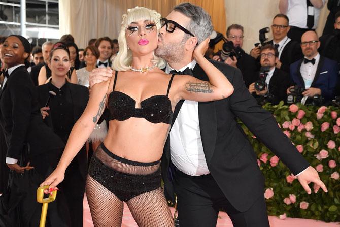 After the black gown, she went on to reveal a body-hugging pink dress. The star slowly slipped out of the pink dress to reveal her black sparkly innerwear and posed on the stairs. In total, the 'A Star Is Born' actor pulled off four dramatic costume changes during her time on the pink carpet!