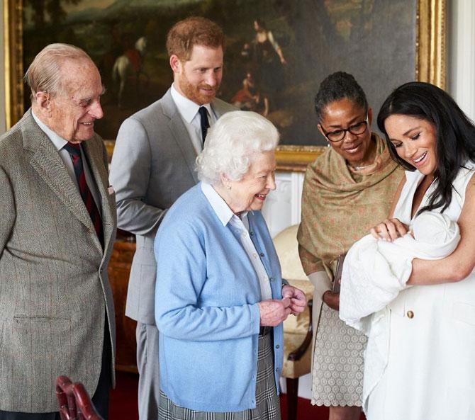 The announcement came with a photo in which their son can be seen meeting his paternal great-grandmother Queen Elizabeth II, and maternal grandmother Doria Ragland, on May 8, 2019