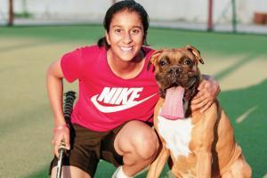 Hockey-playing Jemimah Rodrigues has fun with her dog Theo