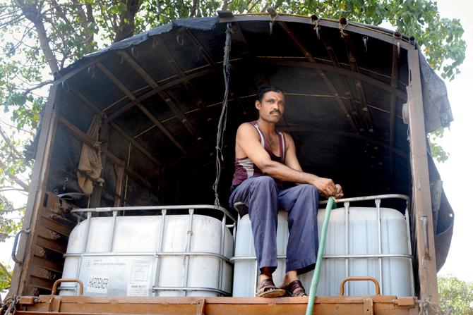 Shivaji Gunde transports water in tanks atop a truck from Mella village to Khopivali every four days, to be transferred into residential tanks