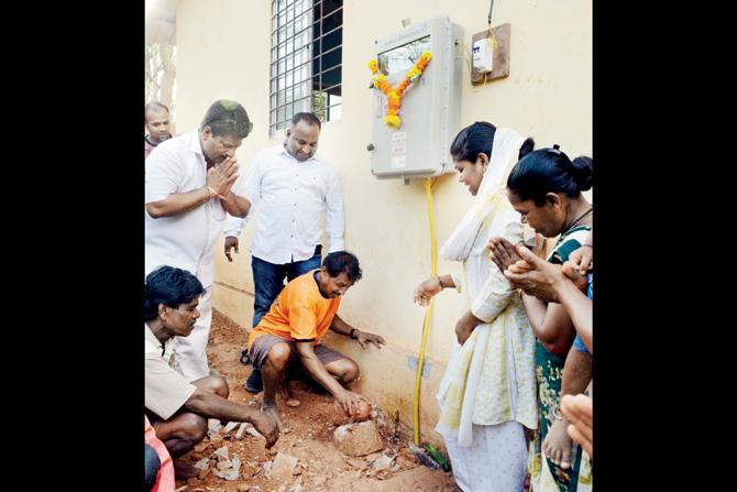 Ecstatic Jamdar Pada villagers conduct a puja at the newly installed electricity meter