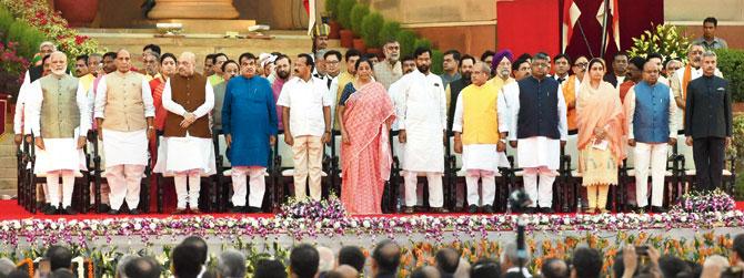 Newly sworn-in Prime Minister Narendra Modi and Cabinet ministers after being administered an oath of office by President Ram Nath Kovind at Rashtrapati Bhavan in New Delhi on Thursday
