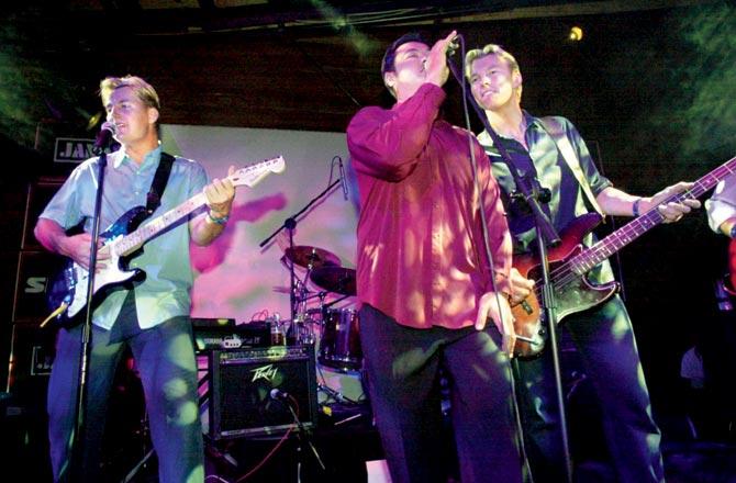 Australian cricketers Shane (left) and Brett Lee join Richard Chee Quee (centre) of the rock band The Nevilles at Last Lap at Home 2000 nightclub during the Sydney Olympic Games in 2000. Brett later sign with Asha Bhosle. Pic/Getty Images 