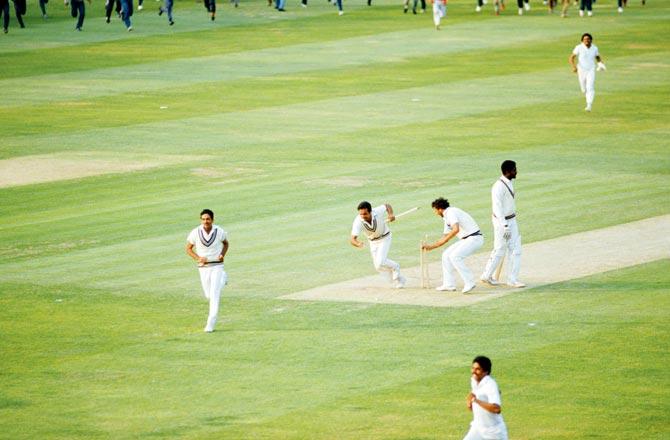 India players Yaspal Sharma and Roger Binny grab souvenir stumps as Mohinder Amarnath (left) runs off the field. West Indies batsman Michael Holding appears stunned at Lord