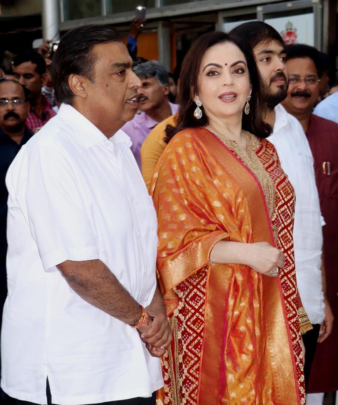 A month before Akash and Shloka's wedding, Nita Ambani was snapped along with Mukesh Ambani and Anant at Siddhivinayak temple in Prabhadevi. For her visit to the temple, Nita sported a red and gold salwar kameez and completed her look with an orange colour silk dupatta and silver heels. She wore pretty diamond earrings to compliment her outfit. Picture/Yogen Shah