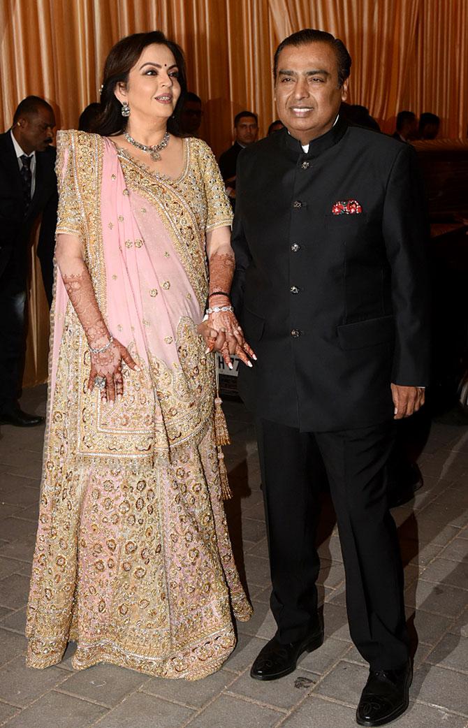 In picture: Nita Ambani stuns in a light pink embellished sari draped in Gujarati style as she arrives for her daughter Isha Ambani's wedding reception held at BKC. Picture/Yogen Shah