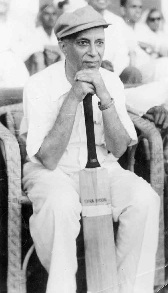 In this photo, he is seen with a cricket bat, curiously watching a match.