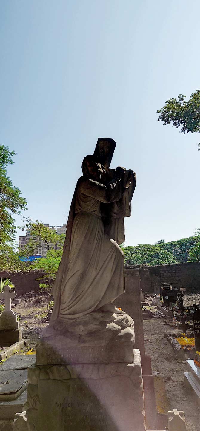 A beautiful white tombstone depicting Jesus Christ carrying the cross