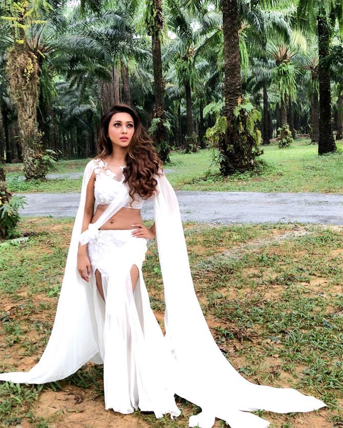 In this stunning photo, Mimi Chakraborty looks like an angel from one of the fairytales in a stunning outfit in hues of white. The Trinamool Congress MP wore this thigh-high slit dress for one of her movie songs. The actress looks classy as she pulls off the outfit with much ease and comfort.