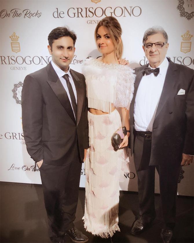 In photo: Adar Poonwalla poses for the lenses with wife Natasha Poonawalla and father Cyrus Poonwalla during an event in France