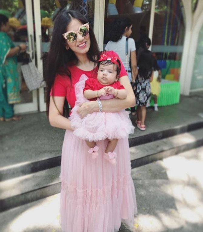 And they are twinning again, in a red and pink dress. While Nishka has accessorised her look with sunglasses, Miraya has donned a beautiful hair band.