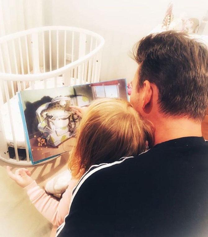 Brett Lee with his daughter. Lee married Lana Anderson in 2014.
He captioned this: Choosing one of my daughters favourite books for our #readandfeed. @karicarelineanz are encouraging all parents to start reading to their kids during feeding time. It’s gentle nutrition for gentle moments.