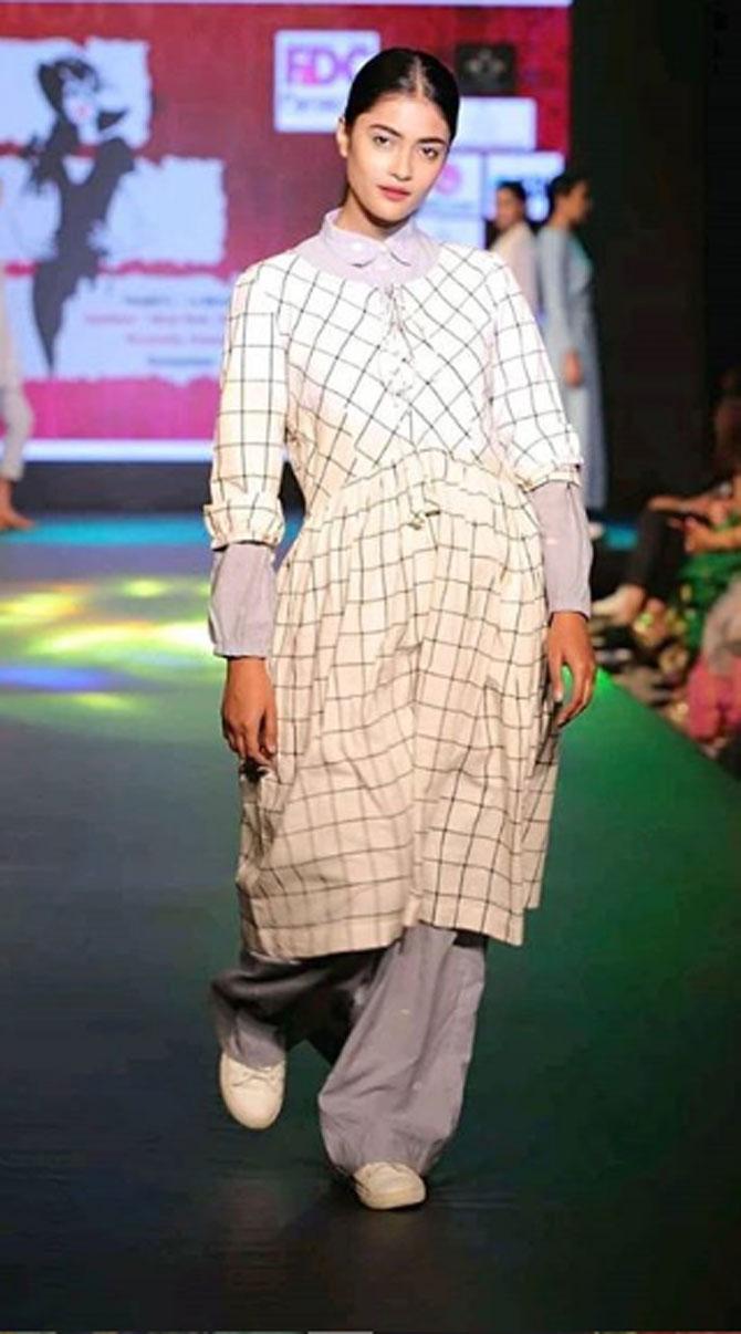 For a fashion show, Jyotishmita wore a checkered white outfit with grey pants. Her hair was tied in a ponytail and she wore a bright-coloured lipstick.