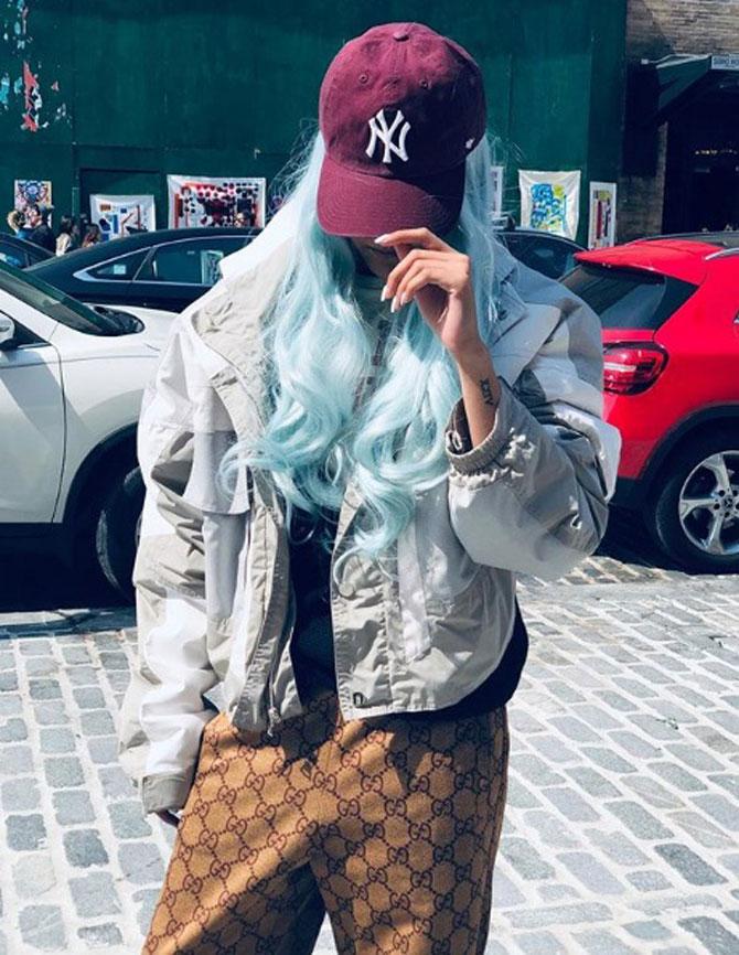 Taking funky to another level, Ananya took a bold step and coloured her hair sky blue, and nobody can rock it like she does. With brown printed pants, a black inner and a grey jacket, Ananya donned a red cap, while hiding her face and said, 