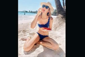 Tennis babe Karolina Pliskova cools off on beach with some watermelon