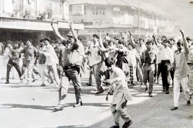 Madhukar Zende (right) at Mohammed Ali Road back in 1992 (left) as he approached the mob gheraoing the police van. Behind him are Muslim youth who helped him calm the protesters