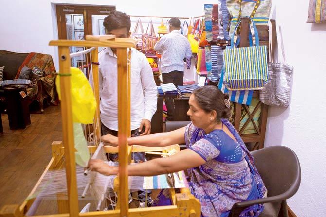 Rajiben Vankar with her loom and woven plastic products