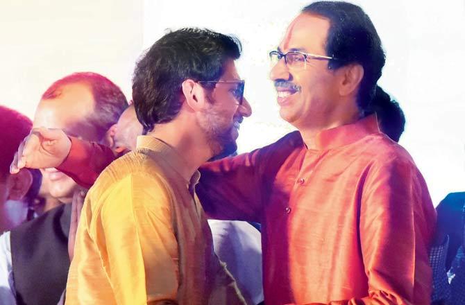 Aaditya Thackeray greets his father Uddhav Thackeray after he took oath