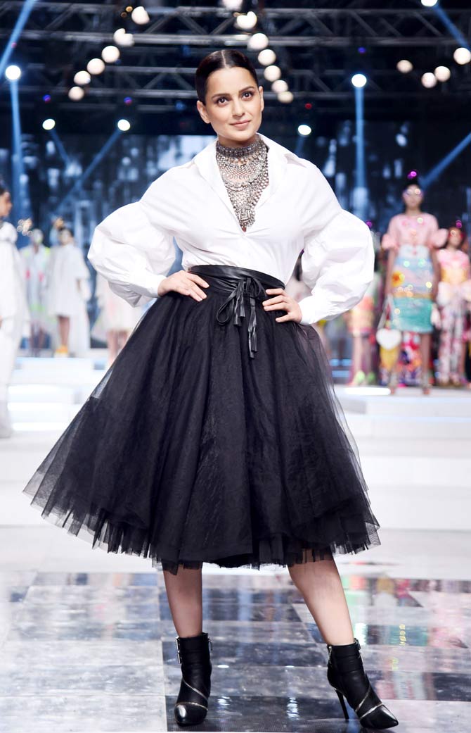 Kangana Ranaut opted for a monochrome look - a white shirt, paired with black mesh skirt. She completed her look with silver neckpiece, a leather belt and black ankle-length boots to walk the ramp.