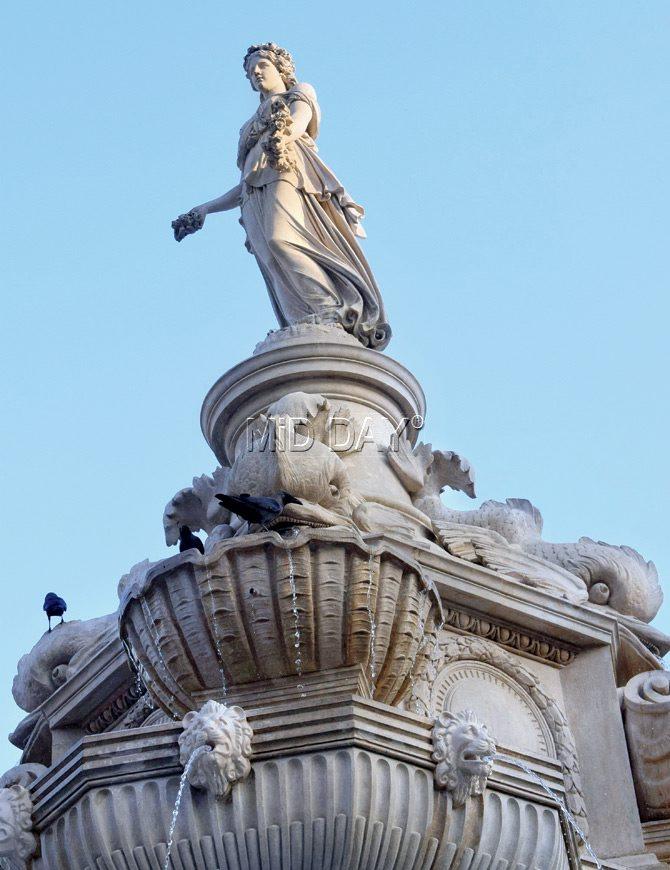 The total height of the fountain is (approx) 33 feet while Lady Flora’s height is about seven feet.
