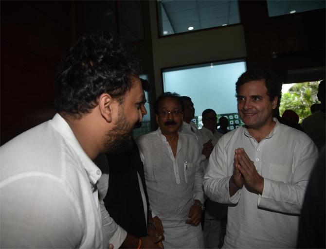 In picture: Zeeshan Siddique greets former Congress president Rahul Gandhi upon his arrival in Mumbai as his father Baba Siddique looks on.