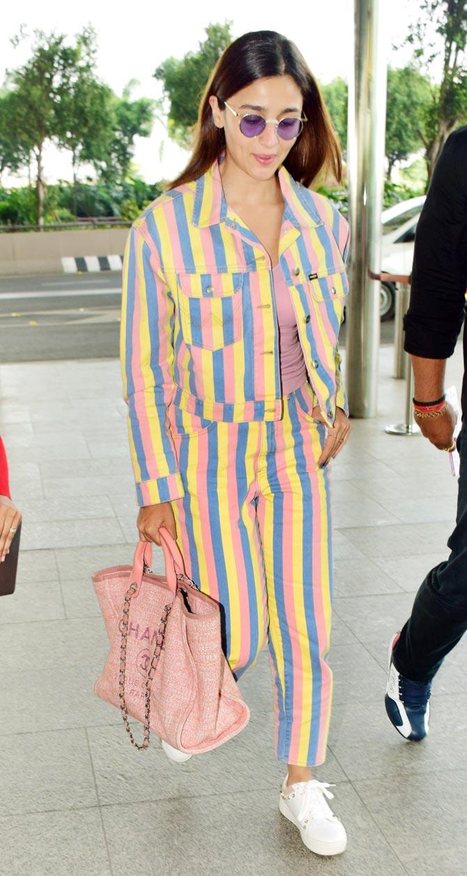 Alia Bhatt was spotted in a trendy co-ord set at the Mumbai airport. The actress' outfit turned heads when she walked in a multicoloured striped outfit, paired with a pretty pink handbag and white sneakers. All pictures/Yogen Shah
