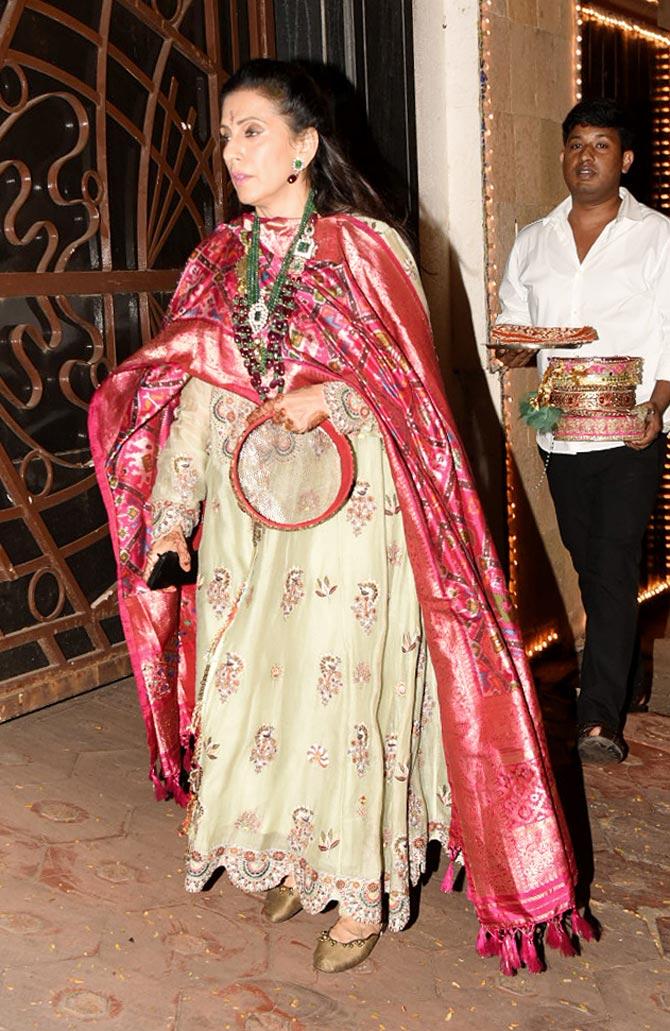 Among a host of celebrities present at the ceremony, Shilpa Shetty Kundra shared a video on Instagram where the 'KC gang' is seen circling around a table and singing a traditional puja song.
In picture: Sunita Kapoor Anarkali dress, which she paired with pink Banarasi dupatta looked ethereal at Karwa Chauth celebration.