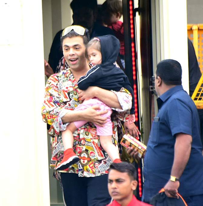 Karan Johar made a bold style statement in an abstract printed shirt and black trousers. He carried little Roohi in his arms and looked excited to take a break from work.