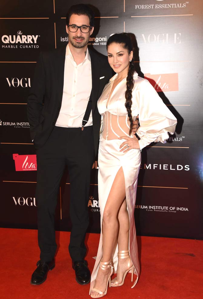 While Daniel Weber walked the red carpet ceremony in suspenders, Sunny Leone added an oomph factor to the red carpet as she walked into a white satin thigh-high slit dress for the event.