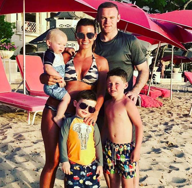 In picture: Wayne Rooney and Coleen Rooney with their four children - Kai, Klay, Kit and Cass.