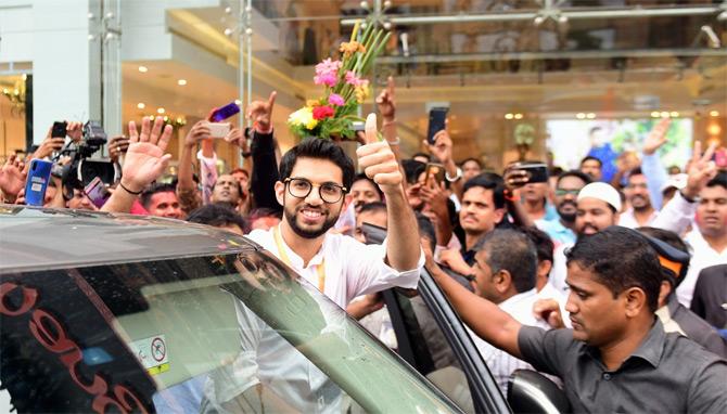 In picture: Yuva Sena chief Aaditya Thackeray shows a thumbs-up sign as he greets the crowd who gathered outside the Election Commission office to congratulate the young leader on his thumping victory in the elections.