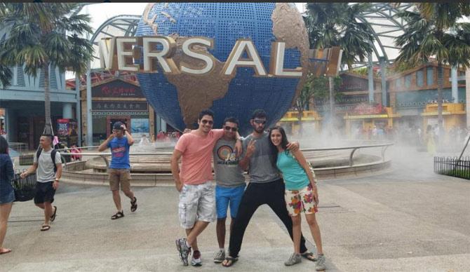 Abhishek Nayar poses with his wife Natasha and family during a trip to Universal Studio in Singapore