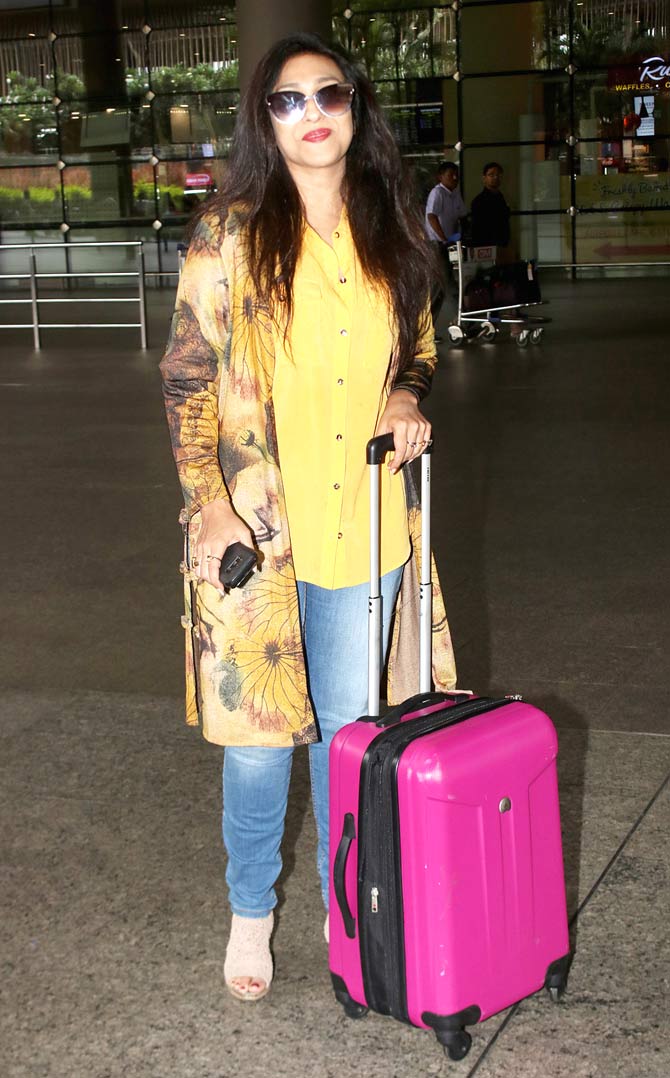 Rituparna Sengupta was all smile as she posed for the photographers at the Mumbai airport.