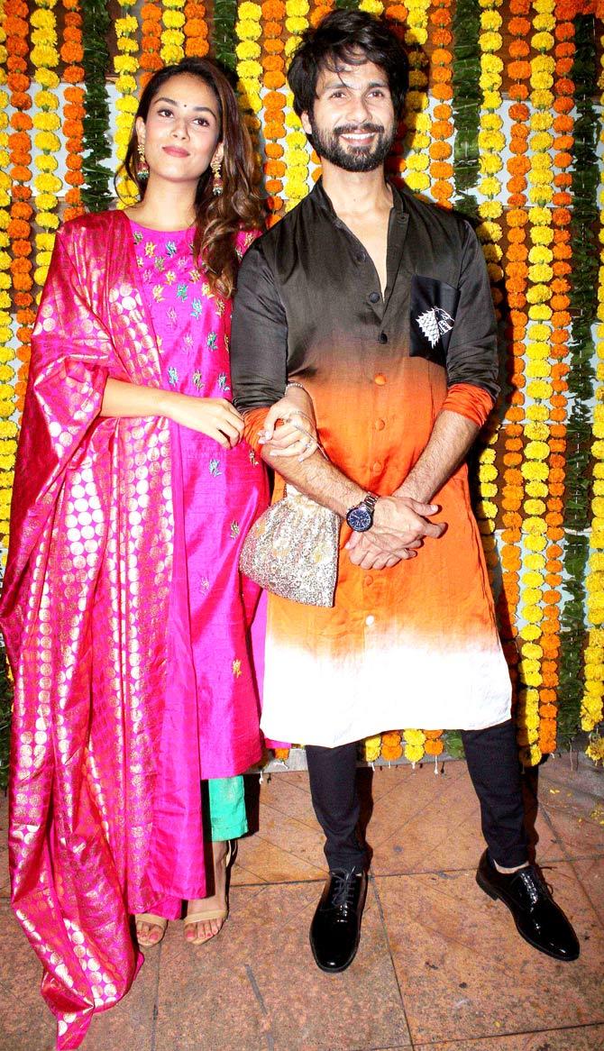 Mira Rajput Kapoor linked arms with Shahid Kapoor as they posed for shutterbugs at Ekta Kapoor's Diwali party. Mira looked gorgeous in a hot pink and teal kurta set, while Shahid opted for a black-orange ombre kurta with black pants.