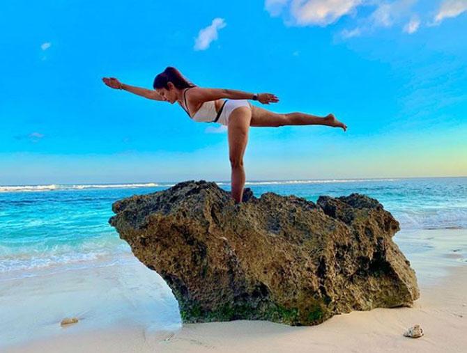 Yasmin Karachiwala strikes a pose known as Arabescue, which is a posture in which one leg is extended backwards at right angles, the torso bent forward, and the arms outstretched, one forwards and one backwards.